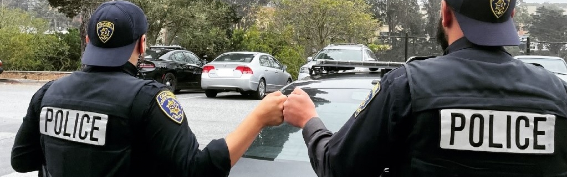 Officers fist bump prior to start of shift