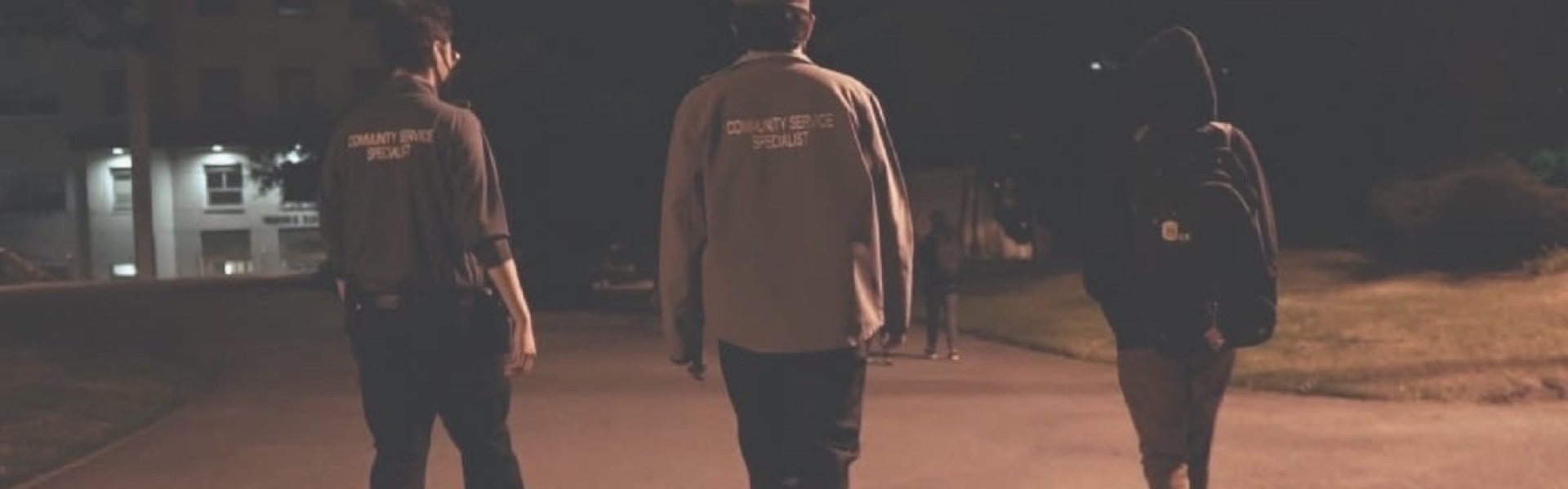 Image of two Community Service Specialists conducting a SafeWalk with a student