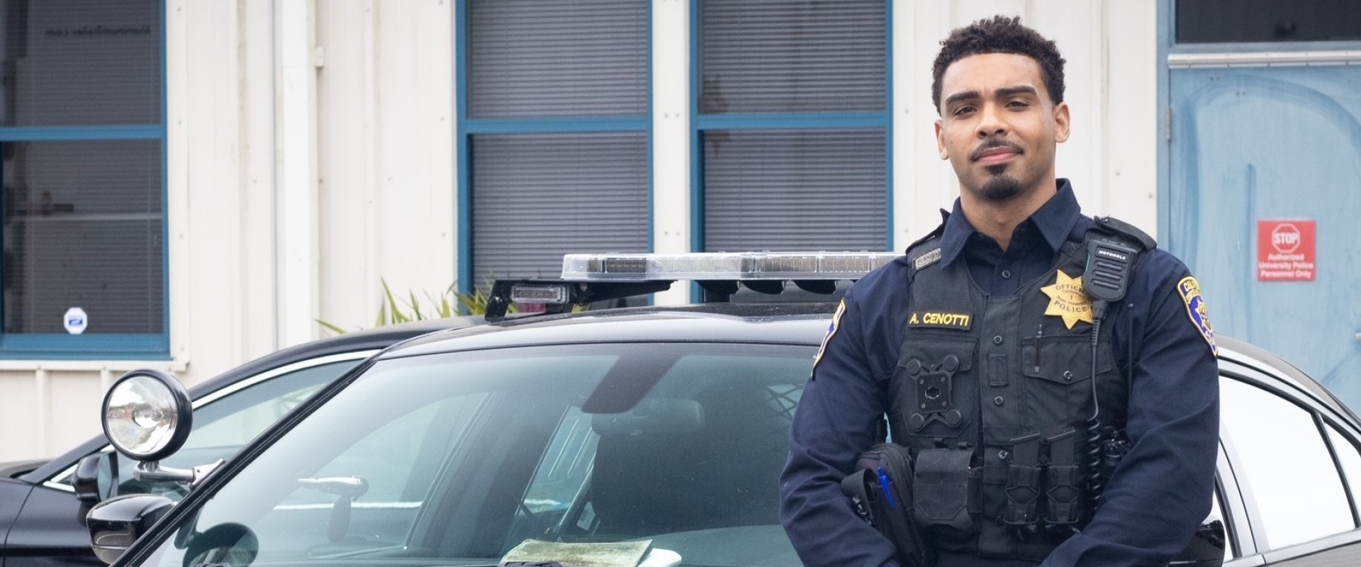 Image of UPD officer standing near his patrol vehicle 